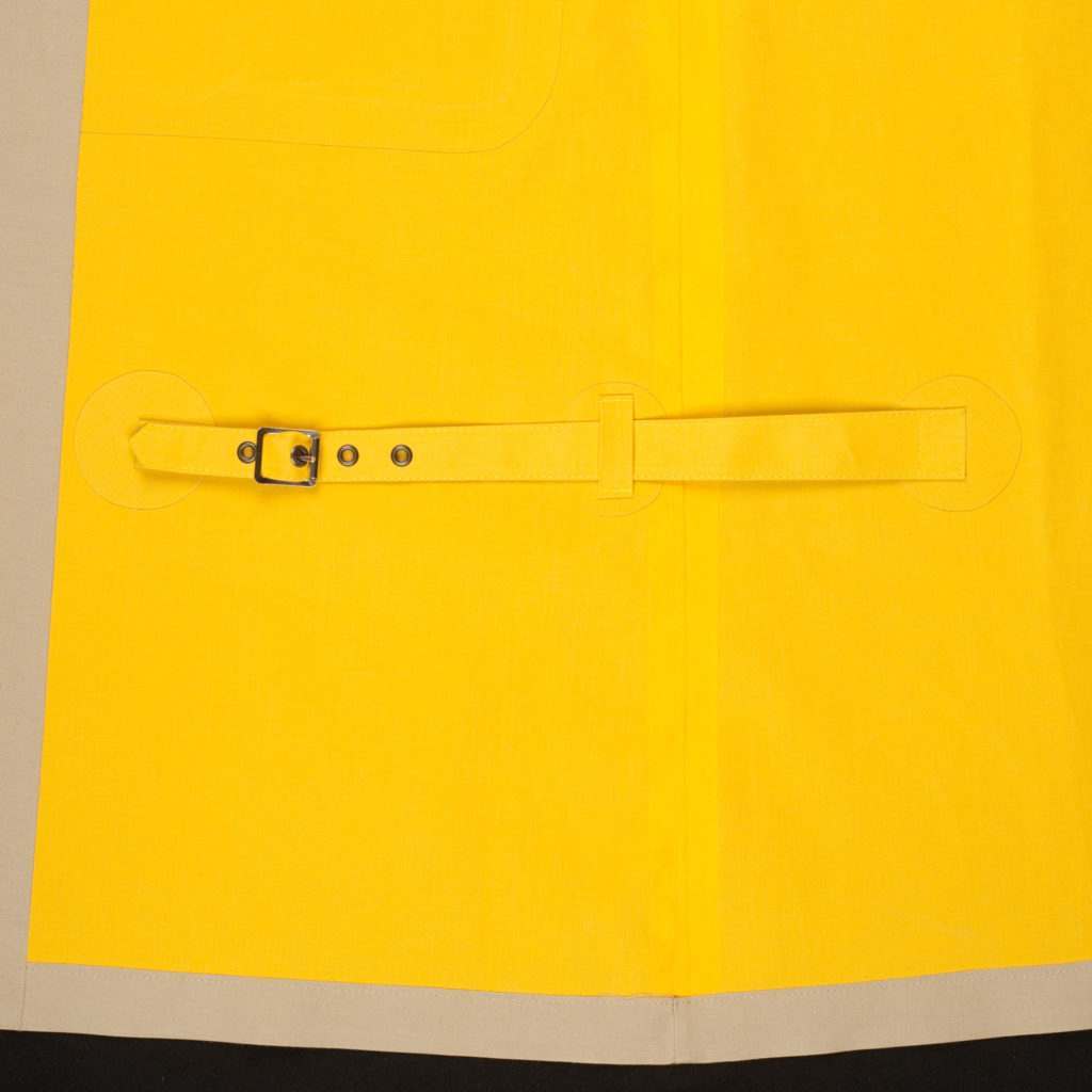 An image of the inside yellow lining of a Cordings Mackintosh with the signature leg strap