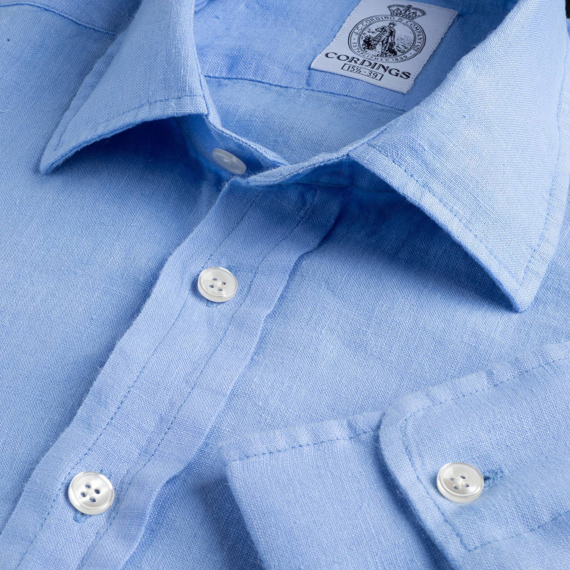 an up close picture of a light blue Cordings linen shirt
