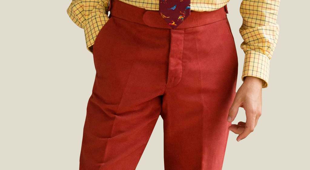 a man wearing a pair of red moleskin trousers