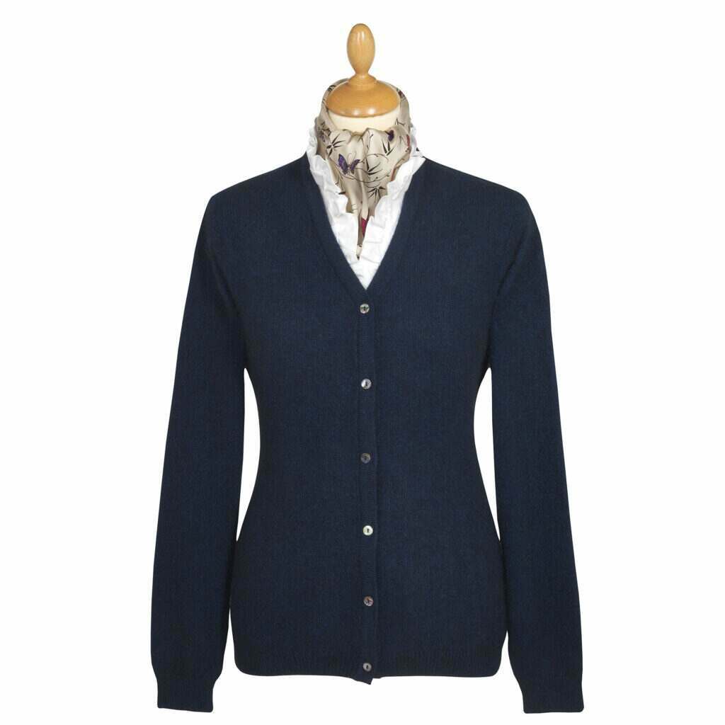 mannequin displaying a navy fine-knit cardigan, with button detailing, over a classic white shirt