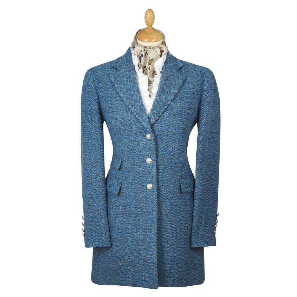 a mannequin displaying a smart blue tweed coat, with white button detailing
