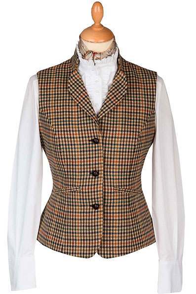 A mannequin displaying a classic tailored waistcoat, over a clean white shirt