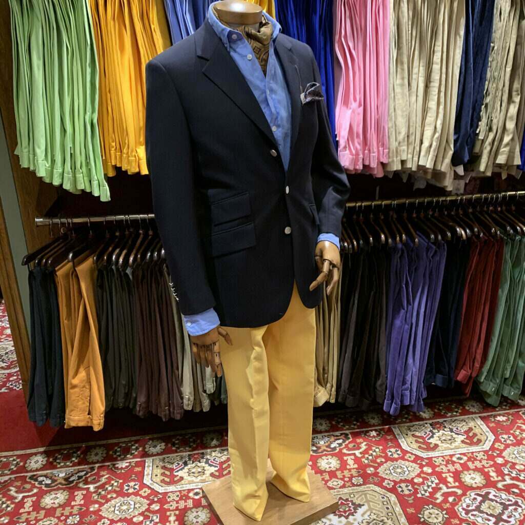 Mannequin in navy serge jacket and lemon corduroy trousers