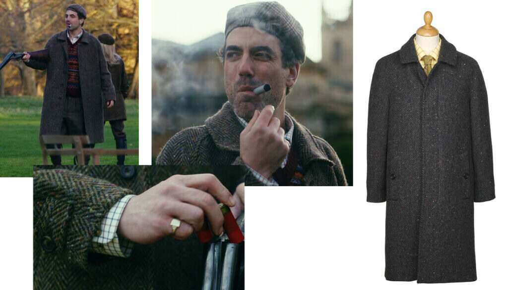 Daniel Ings playing Freddie Horniman in the Netflix series The Gentlemen wearing a Cordings Foolifoot coat whilst smoking a cigar.